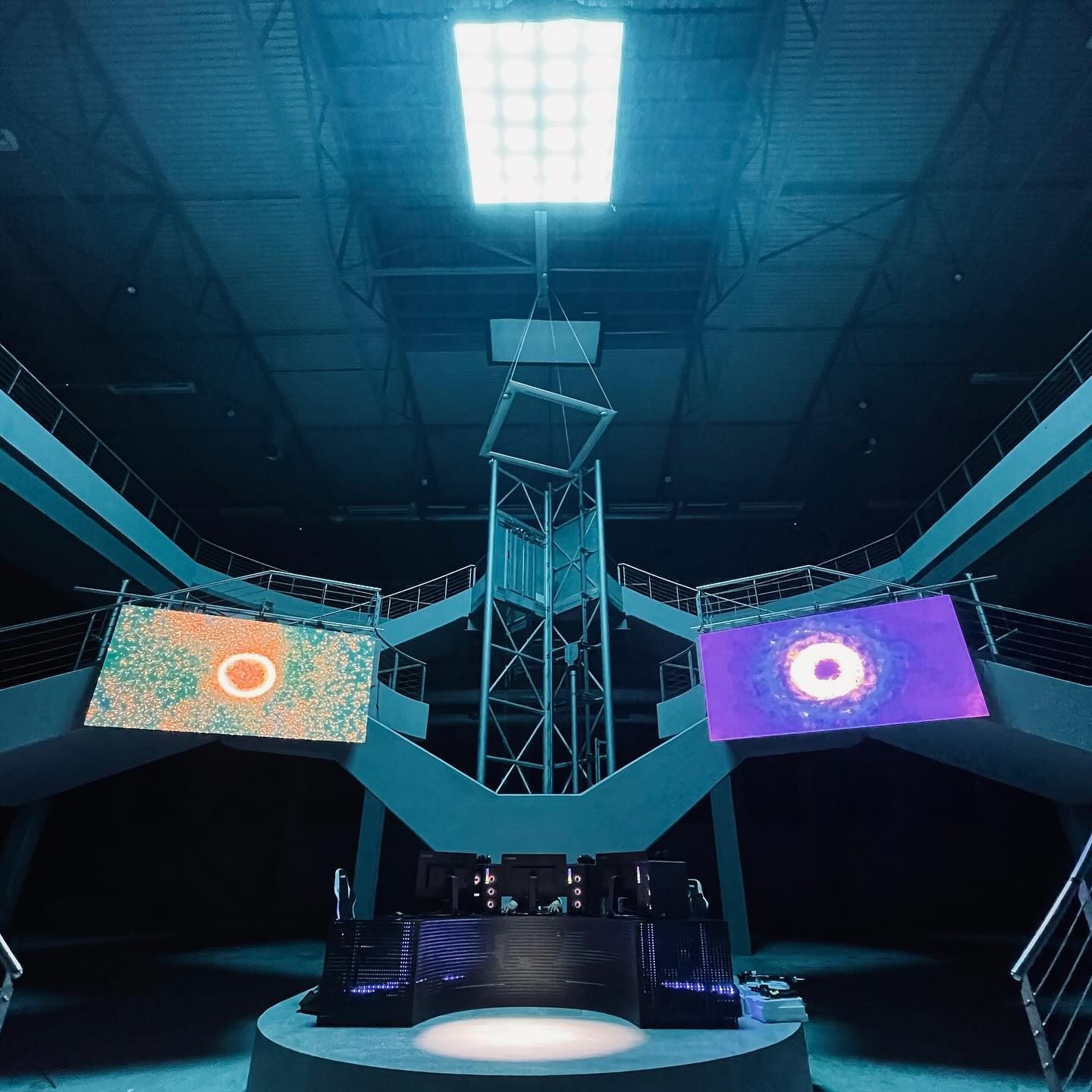 Circular stage with LED screens under a blue toplight