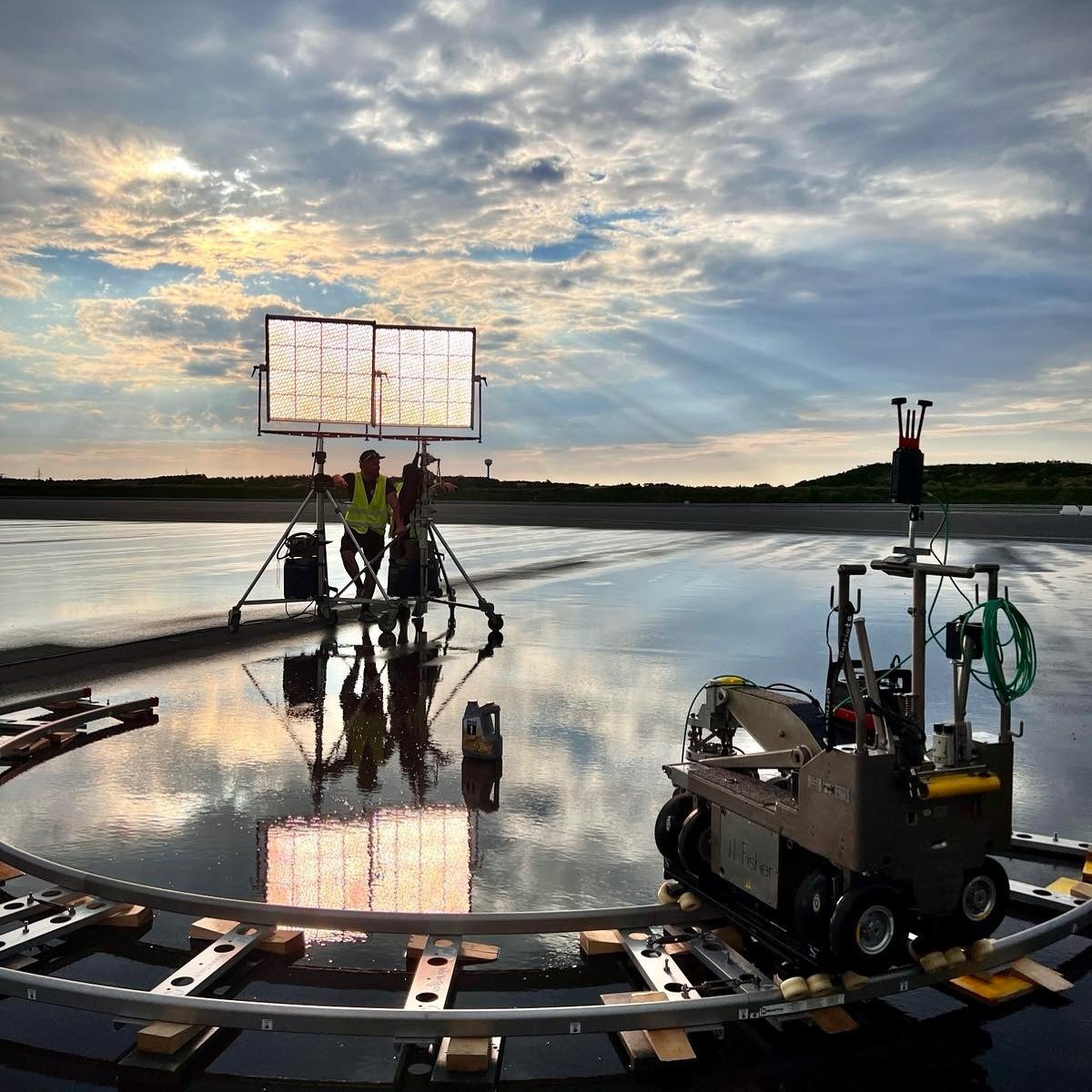 Dolly on curved track with a lighting panel at dawn