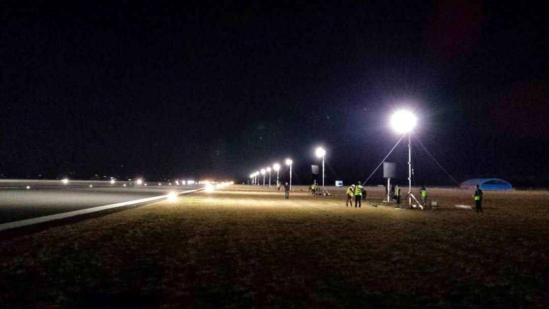 Row of balloon lights along an airfield at night