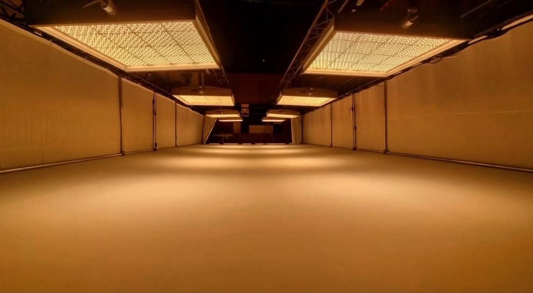Empty studio bathed in warm light from an overhead soft ceiling